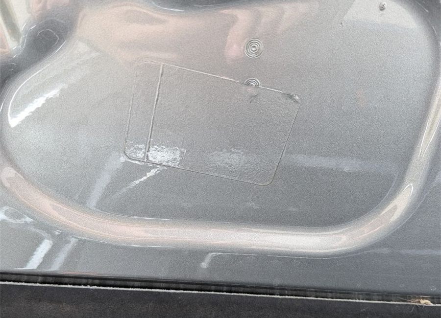 Painted-over label on a part after poor repair